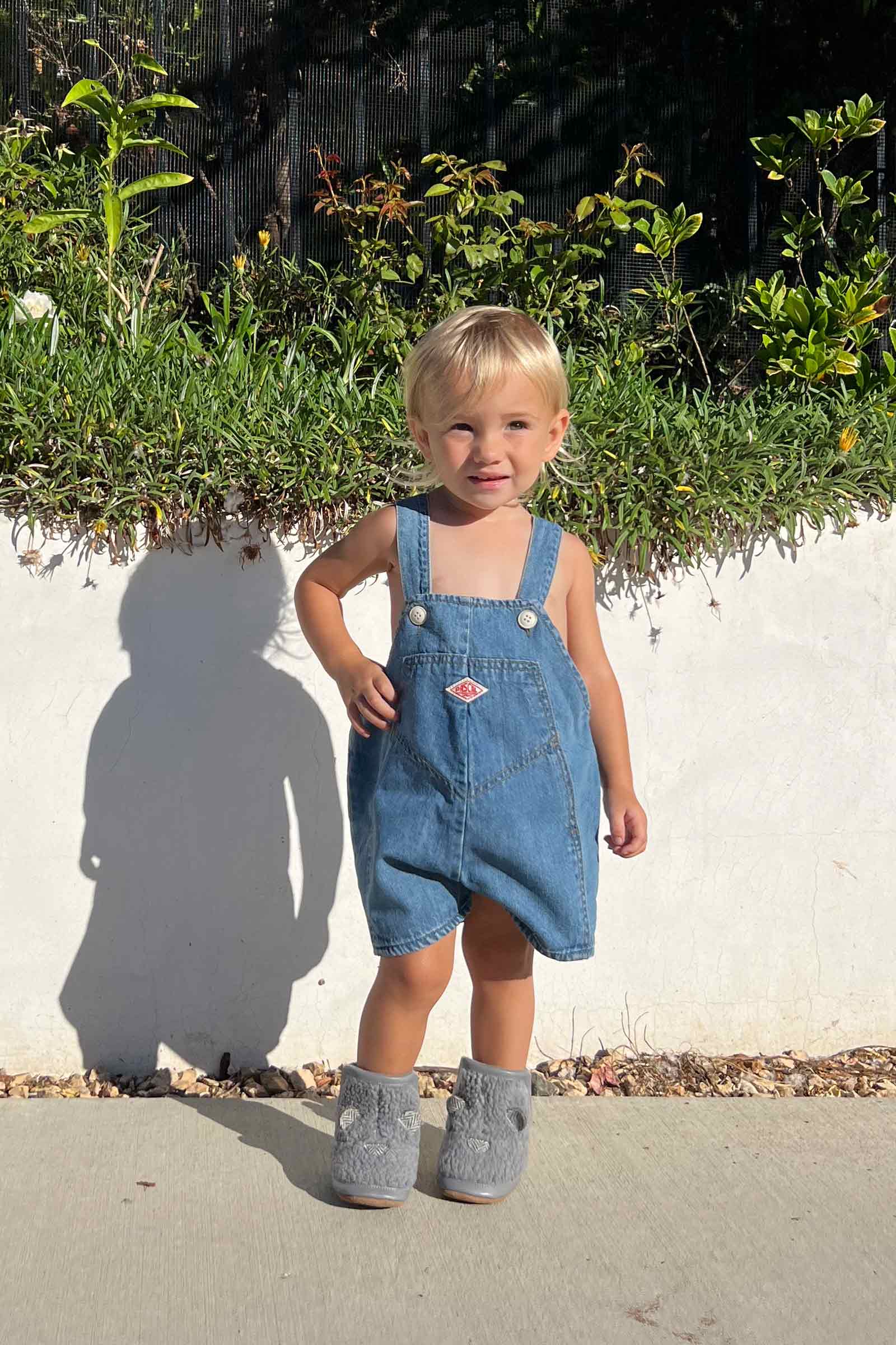 baby girl wearing Wren Soft Sole Boots in Grey